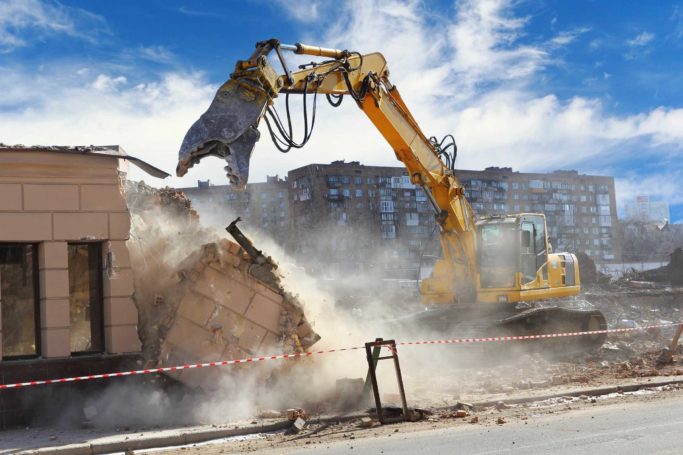 Construction equipment demolishing a building